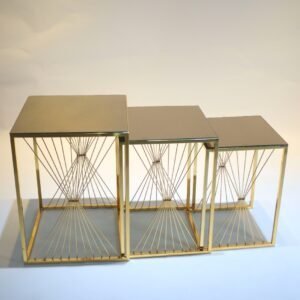 Three gold nesting tables with square tops and decorative metal wire sides, varying in height.