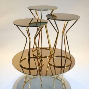 Modern round tables with gold frames and reflective surfaces, arranged in a nested design.