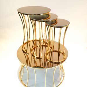 Three nested tables with circular mirrored tops and gold metallic frames in modern design