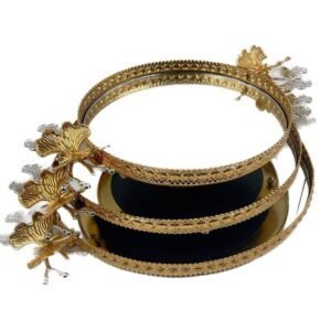 Three-tiered golden tray with intricate patterns and floral embellishments, slightly offset stacking.