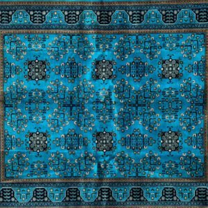 Rectangular blue rug with geometric and floral patterns, concentric borders, and central motif.