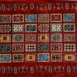 Red rug with a floral border, grid of colorful designs, motifs in blue, green, yellow, red.