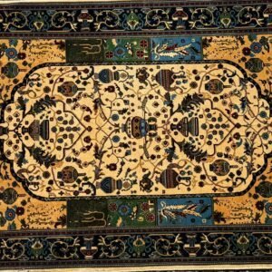 Intricate woven carpet with floral and geometric patterns in gold, blue, green, and black.